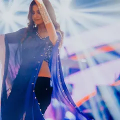 A beautiful action shot of Kinjal Dave dancing on stage. The silver oxidized hathphool adds a touch of traditional grace to her modern, edgy look.