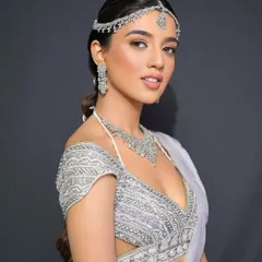 A front view of the modern bride, her sleek hairstyle putting all the focus on her beautiful features and stunning diamond jewelry.