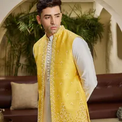A closer view of the yellow jacket, highlighting the intricate threadwork along the placket and hem. It's these details that elevate a simple outfit.