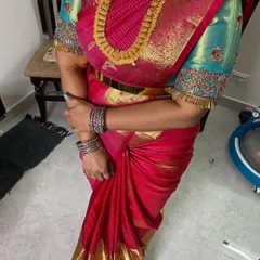 A perfectly draped pink Kanjivaram saree, showing how the pleats fall neatly. I ensure the drape is comfortable and looks great from every angle.