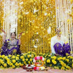 A playful flower fight between the couple during their Haldi, set against a backdrop of marigolds. This is the kind of candid, colorful fun we love to document.