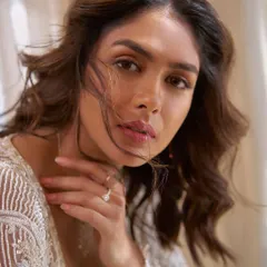 A close-up from the Mrunal Thakur shoot. The soft lighting and windswept hair complement the delicate embroidery of the jacket, showcasing a moment of quiet beauty.