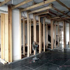 The wooden framework for the 'lantern' partitions being installed at the Lucknow penthouse. This behind-the-scenes shot reveals the underlying structure that supports the backlit Chikankari fabric panels.