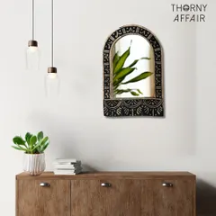 Inspired by the beautiful jharokha windows of Rajasthan, this arched wooden mirror brings architectural elegance to your wall. The intricate carvings and dark finish make it a timeless statement piece, perfect for an entryway or above a console table.