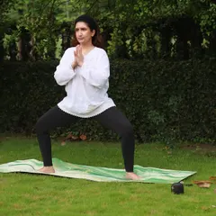 Demonstrating Utkata Konasana, or Goddess Pose, during an outdoor class. This pose is fantastic for building strength in the legs and opening the hips.
