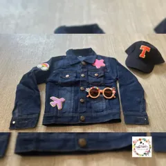 The front of the custom denim jacket, featuring more fun patches like a rainbow and a star. The set also includes personalized sunglasses.