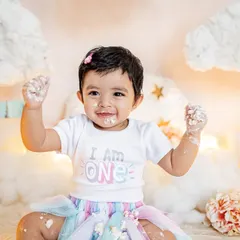 This little one is proud to be one and isn't afraid to get messy. The "I am ONE" shirt and a face full of frosting make for the perfect cake smash photo.