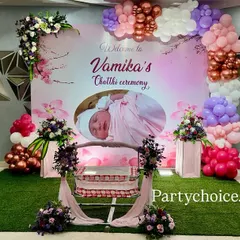 A modern take on a Chhathi or Thottil ceremony, using a personalized photo backdrop and a beautiful arrangement of pastel and metallic balloons to frame the cradle.