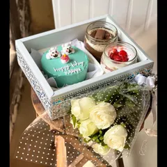 For the ultimate gift, I offer this beautiful hamper. It features a custom light blue bento cake with adorable polar bears, two delicious cake jars, and a fresh bouquet of white roses, all presented in an elegant, decorated tray.