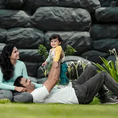 Playtime with dad is always the best. We captured this sweet, candid moment of a father lifting his smiling son during a relaxed family photoshoot on our lawn.