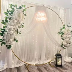For a modern and elegant engagement or reception, I design stunning backdrops like this one. It features a gold circular frame adorned with lush white flowers, sheer drapes, and a custom 'Better Together' neon sign, all set against a backdrop of twinkling fairy lights.
