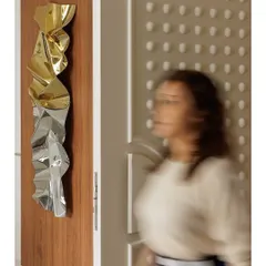 An artistic shot capturing my sculpture next to the apartment's textured main door, a space where art and design meet.