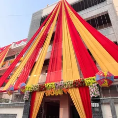 A closer look at the wedding house entrance, showing the floral arrangement and the "Shadi Wala Ghar" sign.