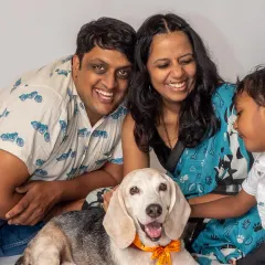 A family photo filled with smiles and a very happy beagle. These are the heartwarming moments that make a house a home, captured during a relaxed studio session.