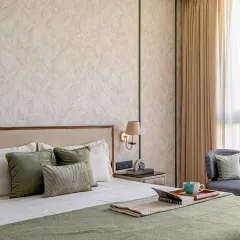 This view shows the custom upholstered bed and the small accent chair we built for a master bedroom. The soft, neutral fabrics and clean lines contribute to a calm and minimalist aesthetic, perfect for a relaxing retreat.