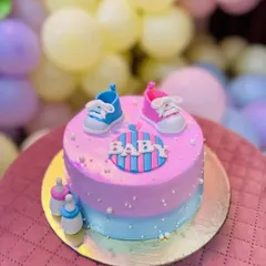 He or she, what will the baby be? This pink and blue baby shower cake with tiny fondant shoes and bottles is the sweetest way to celebrate a new arrival.
