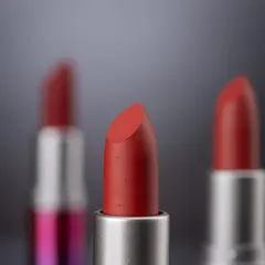 A detailed macro shot with a shallow depth of field, focusing on the texture of one lipstick bullet while others blur into the background. This creates a sense of depth and artistry.