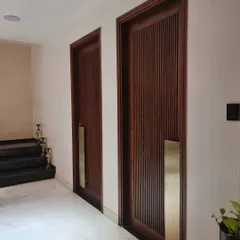 For us, doors narrate the story of a space. These plush, fluted teak wood doors feature custom-designed, full-height brass handles, making a grand and luxurious statement at the entrance to a room.