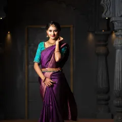 Another elegant pose from the same traditional saree shoot. The setting, with its temple-like pillars, adds to the classic and regal atmosphere.
