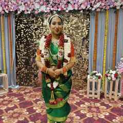 A beautiful client ready for a ceremony in a green Madisar saree. This nine-yard drape requires a special technique without a petticoat, a skill I cover in detail in my regional draping classes.