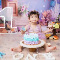 Getting ready for a magical underwater adventure with this mermaid-themed first birthday cake smash. The pastel colors and sea-themed props create such a dreamy scene.