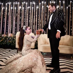 The modern proposal, where she takes the lead. This beautiful moment shows a partnership of equals, captured against a stylish, contemporary backdrop.