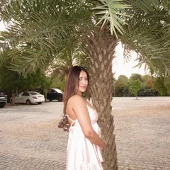 A light pink babydoll dress, perfect for exploring a new city or a day at a resort.