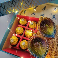 My Diwali gift hampers are perfect for corporate or personal gifting. These boxes are filled with treats, hand-painted diyas, and fairy lights to bring a festive glow.