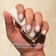 A chic and modern take on the nude nail. This design features a soft, semi-sheer base with a clean, metallic silver line at the cuticle, adding a subtle yet sophisticated detail to a classic look.