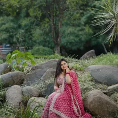 A wider shot of Dr. Meghana's outdoor photoshoot for her ring ceremony. The makeup is designed to look fresh and radiant in a natural setting.