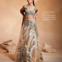 The Ivy Lehenga Set, showcasing a unique blend of soft pastel prints and shimmering hand-embroidery. The organza layered lehenga creates a light, ethereal silhouette, ideal for daytime celebrations and evening parties.