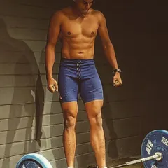 Chalked hands, a loaded bar, and an empty platform. This is the perfect recipe for a good workout and the foundation for building powerful legs.