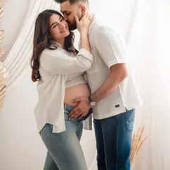 A gentle kiss and a hand on the belly. These are the simple, loving gestures I aim to capture during a relaxed couple's maternity session.