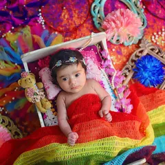 Even the tiniest babies can celebrate Holi! This newborn is wrapped in a rainbow of colours, creating a safe and beautiful way to mark their first festival of colours.