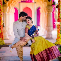 A tender moment on a decorated swing, with the couple in vibrant traditional outfits. The colorful setup and their loving gaze make this a perfect pre-wedding shot.