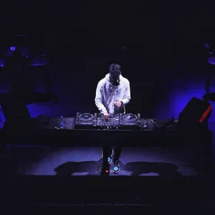 A powerful shot of me on a dark stage, just me and my decks.