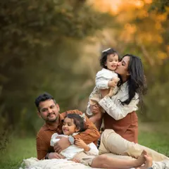A playful moment during a family picnic session. Mom gives her little one a kiss while dad and big sister share a cuddle. These are the authentic interactions I love to capture.