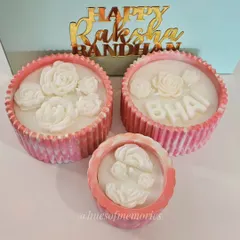 A set of my Rakhi candles ready for gifting. The pink marble jars are decorated with wax roses and letters. They come in a beautiful box with a "Happy Raksha Bandhan" tag.