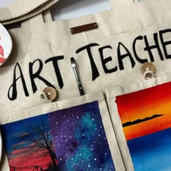 A close-up view of the hand-painted details on the "Art Teacher" tote bag. The bag is made of sturdy canvas and the paintings are sealed with varnish, so the art is durable and can withstand gentle washing.