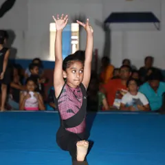 The look of pure focus and determination. This young gymnast is in the zone during her floor routine at our in-house event.