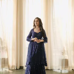 A three-quarter shot that focuses on the detailed sequin work and the flattering silhouette of the lehenga.