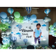 A hot air balloon theme for a second birthday, with a custom photo backdrop.