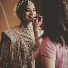 A candid moment of putting the final touches on the bride's makeup. I ensure every detail is perfect before she walks down the aisle.
