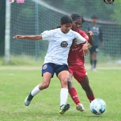 A fierce duel for the ball. This photo shows one of our players battling for possession, demonstrating the physical and competitive nature of the game.