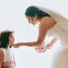 A tender moment between the bride and her flower girl. The soft, natural makeup looks beautiful in these heartfelt, candid shots.