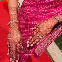 The 24-hour stain result on a bride, perfectly complementing her pink bandhani saree. You can see the rich, dark color that my natural henna produces.