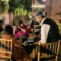 My attentive staff serving snacks directly to guests at their tables. This personalized service is perfect for evening parties and ensures everyone feels well-cared for.