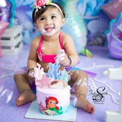 A happy little mermaid enjoying her first taste of birthday cake. I love how her smile shines, even with a bit of frosting on her face. These are the sweet, messy memories that you will look back on and laugh about for years.