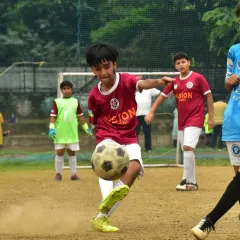 A young player connects with the ball for a powerful strike. We train our players to be confident and decisive in front of the goal.