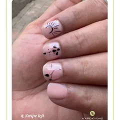 Our minimalist nail art focuses on clean lines and simple motifs, like this chic sun design, offering a modern and subtle way to express your style.